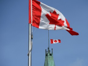 The Canadian flag on top of the Peace Tower on Parliament Hill will fly at half-mast in Ottawa on May 12. (File photo)