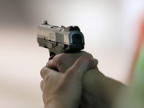 A woman fires a handgun at the "Get Some Guns & Ammo" shooting range on January 15, 2013 in Salt Lake City, Utah.
