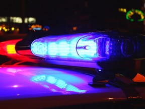 A close-up photo of police lights by night