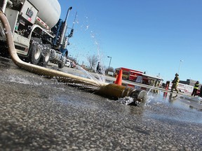Water leaks from a tanker at a London Line refueling station in Sarnia Tuesday. Sarnia firefighters were conduction a training exercise, one of three held yearly, involving members of the local service's hazardous materials team. (Tyler Kula, The Observer)