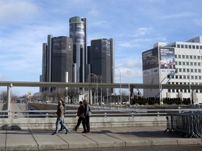 The top of the towers of the Renaissance Center, which serves as General Motors' world headquarters, are seen wrapped with images of vehicles before press days of the North American International Auto Show in Detroit, Michigan January 9, 2016. REUTERS/Rebecca Cook