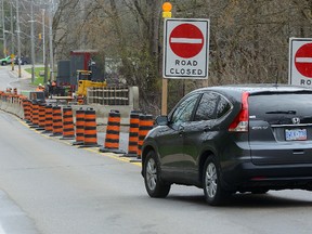 Vehicles drive the wrong way through a closed section of Windermere Road just west of Adelaide Street on Monday May 2, 2016. (MORRIS LAMONT, The London Free Press)