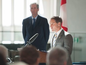 Cameron Friesen is sworn in as finance minister as Manitoba Premier Brian Pallister looks on in Winnipeg, Tuesday, May 3, 2016.