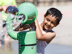 Shavd Brar, 6, plays in the spray park at Jackie Parker Park on a hot day in Edmonton, Alta., on Tuesday May 3, 2016. A Special Weather Statement has been issued by Environment Canada calling for record breaking high temperatures in the greater Edmonton region. Photo by Ian Kucerak