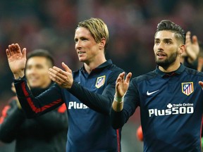Atletico's Fernando Torres, left, celebrates with teammate Yannick Carrasco after advancing to the final after the final whistle of  the Champions League second leg semifinal soccer match between Bayern Munich and Atletico de Madrid in Munich, Germany, Tuesday, May 3, 2016. (AP Photo/Michael Probst)
