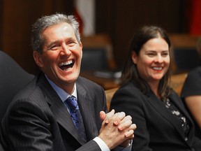 Manitoba Premier Brian Pallister (l) and attorney general Heather Stefanson,  enjoy a light moment while speaking to the media prior to their first cabinet meeting in Winnipeg, Man. Tuesday May 03, 2016.
