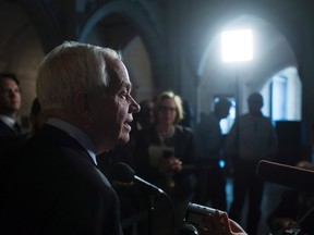 Minister of Immigration, Refugees and Citizenship John McCallum speaks with reporters following a cabinet meeting on Parliament Hill in Ottawa, Tuesday April 19, 2016. THE CANADIAN PRESS/Adrian Wyld