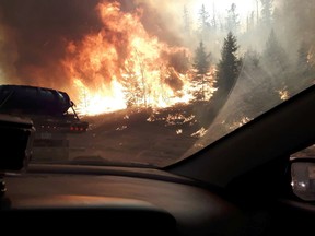 Wildfires on Highway 63 southbound as residents of Fort McMurray leave the downtown area on Tuesday May 3, 2016. (Robert Murray photo)