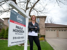 Sutton real estate sales representative Paula Hodgson stands outside a listing on Manchester Road. (CRAIG GLOVER, The London Free Press)