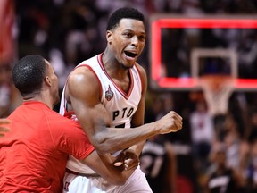 Toronto Raptors' Kyle Lowry reacts after making a buzzer beater three-point basket to tie the game against the Miami Heat during Game 1 of a second-round NBA playoff series at the Air Canada Centre in Toronto on May 3, 2016. (THE CANADIAN PRESS/Frank Gunn)