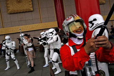 A man dressed as the character Poe Damaron (R) from "Star Wars" takes a selfie during Star Wars Day in Taipei, Taiwan, May 4, 2016. REUTERS/Tyrone Siu