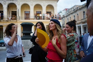 Brazilian top model Gisele Bundchen, second right, attends the presentation of fashion designer Karl Lagerfeld's "cruise" line for fashion house Chanel, at the Paseo del Prado street in Havana, Cuba, Tuesday, May 3, 2016. With the heart of the Cuban capital effectively privatized by an international corporation under the watchful eye of the Cuban state, the premiere of Chanel 2016/2017 "cruise" line offered a startling sight in a country officially dedicated to social equality and the rejection of material wealth. (AP Photo/Ramon Espinosa)