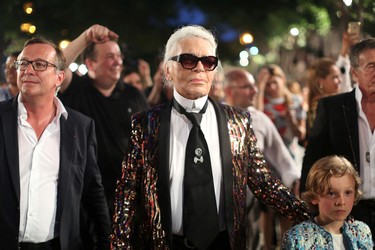 German photographer Karl Lagerfeld (C), head designer and creative director of fashion house Chanel, walks with a model after a fashion show of his latest inter-seasonal Cruise collection, at the Paseo del Prado street in Havana, Cuba, May 3, 2016. REUTERS/Alexandre Meneghini