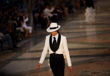 A model wears a creation from the Karl Lagerfeld "cruise" line for fashion house Chanel, at the Paseo del Prado street in Havana, Cuba, Tuesday, May 3, 2016. With the heart of the Cuban capital effectively privatized by an international corporation under the watchful eye of the Cuban state, the premiere of Chanel 2016/2017 "cruise" line offered a startling sight in a country officially dedicated to social equality and the rejection of material wealth. (AP Photo/Ramon Espinosa)