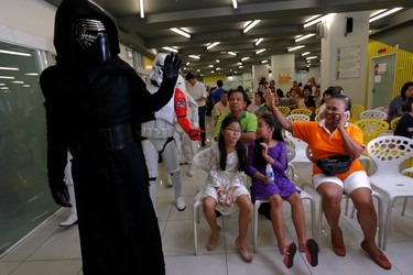 Members of a Star Wars fan club in Thailand, dressed as Kylo Ren, entertains children during Star Wars Day celebration at the Queen Sirikit National Institute of Child Health in Bangkok, Thailand, May 4, 2016. REUTERS/Chaiwat Subprasom