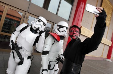 Fans dressed as movie Star Wars characters take photos to cerebrate the Star Wars Day in Taipei, Taiwan, Wednesday, May 4, 2016.  May 4 is known as Star Wars Day to fans worldwide since the date is similar to the franchise's slogan, "May the Force Be With You." (AP Photo/Chiang Ying-ying)