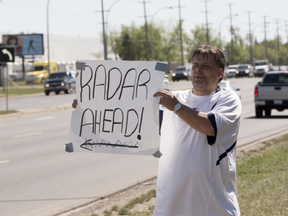 Jack Shultz was fined $500 for warning drivers of upcoming speed traps but plans to fight the ticket in court and continues to warn motorist about photo radar on May 3, 2016 in Edmonton.  Greg Southam-Postmedia Network