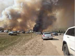 Abandoned vehicles litter Highway 63, south of Fort McMurray, Alta., as residents fled the wildfire engulfing the city on Tuesday, May 2, 2016. Fuel shortages are being reported in the evacuation area. (Brian Langton/THE CANADIAN PRESS)