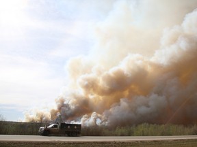 Residents of Fort McMurray flee southbound on Highway 63 Tuesday. Wildfires forced the evacuation of the city Tuesday as high temperatures and winds continued to batter the region. Robert Murray/Fort McMurray Today/Postmedia Network