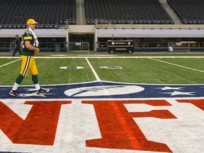 In this Feb. 1, 2011 file photo, Green Bay Packers quarterback Aaron Rodgers walks across the NFL logo as he departs media day for Super Bowl XLV at Cowboys Stadium in Arlington, Tex. (REUTERS/Brian Snyder)