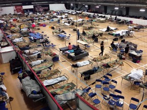 Cots litter the gym floor at an evacuee reception centre set up and operated by the regional municipality of Wood Buffalo in Anzac, Alta., on Wednesday, May 4, 2016. Raging forest fires whipped up by shifting winds sliced through the middle of the remote oilsands hub city of Fort McMurray Tuesday, sending tens of thousands fleeing in both directions and prompting the evacuation of the entire city. THE CANADIAN PRESS/Mike Allen