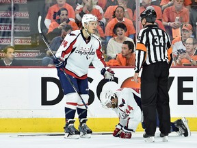 Washington Capitals defenceman Brooks Orpik (44) is injured as teammate John Carlson questions referee Brad Meier (34) during Game 3 of the first round of the 2016 Stanley Cup playoffs at Wells Fargo Center. (Eric Hartline/USA TODAY Sports)