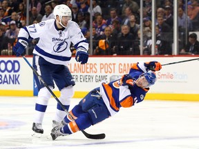 Islanders defenceman Thomas Hickey (right) is checked to the ice by Lightning defenceman Victor Hedman (left) during third period NHL playoff action at Barclays Center in Brooklyn, N.Y., on Tuesday, May 3, 2016. (Anthony Gruppuso/USA TODAY Sports)
