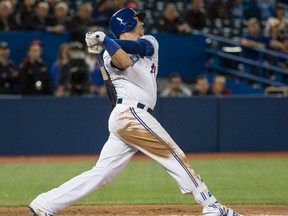Blue Jays' Justin Smoak hits the game-winning home run in extra innings on Tuesday night against Texas. (CRAIG ROBERTSON/Toronto Sun)