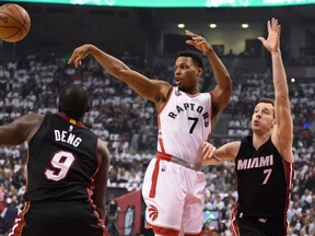Toronto Raptors guard Kyle Lowry makes a pass as Miami Heat’s Luol Deng (9) and Goran Dragic (7) defend during Game 1 of their second-round NBA playoff series at the Air Canada Centre Tuesday, May 3, 2016. (THE CANADIAN PRESS/Frank Gunn)