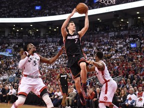 Toronto Raptors' DeMarre Carroll defends as Miami Heat's Goran Dragic drives to the basket during Game 1 of the second round NBA playoff series against at the Air Canada Centre in Toronto on May 3, 2016. (THE CANADIAN PRESS/Frank Gunn)