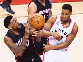 Miami Heat forward Udonis Haslem (40) looses the ball next to Toronto Raptors guard Kyle Lowry (7) during NBA playoff action in Toronto on Tuesday, May 3, 2016. (THE CANADIAN PRESS/Nathan Denette)