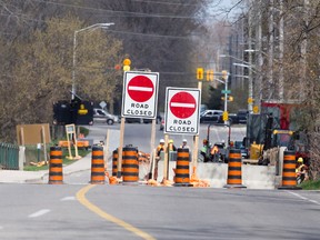 Construction pylons stretch across both lanes of Windermere Road, which is closed for repairs to the Stoney Creek bridge that are scheduled to last until November, in London. The road sees up to 13,000 vehicles use the route daily.  (CRAIG GLOVER, The London Free Press)