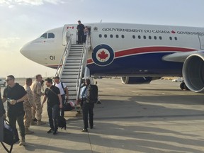 Members of Team Canada 2016 deboard the plane in Kuwait, the first of three stops over seven days. (Supplied)