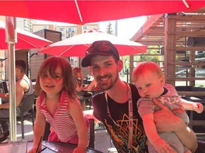 Lawrence Cooper with his children, Tegan Rae, two, and Dax, eight months, on the patio at Earls in downtown Edmonton Wednesday, May 4, 2016. Cooper is a chef at Earls in Fort McMurray who fled the city with his wife, Katie Maher, and their three children, including five-year-old Austin. Liane Faulder