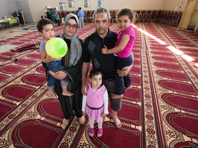 Fort McMurray wildfire evacuees Mohamed Bouchaala, his wife Fatma Louati, and their children Shayma Bouchaala, 5, Hend Bouchaala, 3, and Haydar Bouchaala, 2, pose for a photo at the Al Rashid Mosque, 13070 - 113 St., where they are now staying, in Edmonton Alta. on Wednesday May 4, 2016. Mohamed, who did not have enough gas to safely get his family out of Fort McMurray, went to the airport and rented a car that came with a full tank of gas. Photo by David Bloom