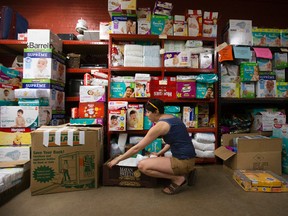 A volunteer sorts donations for Fort McMurray wildfire evacuees at the Edmonton Emergency Relief Services, 10255 - 104 St., in Edmonton Alta. on Wednesday May 4, 2016. (David Bloom photo)
