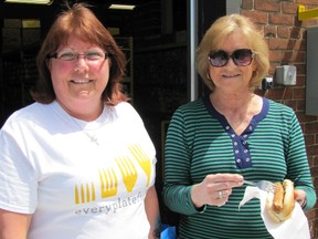 Cindy Parry, left, secretary at Outreach For Hunger, and volunteer Helen MacDonald, were among those who helped feed about 300 people during a free barbecue held at the Wellington Street food bank on May 3.