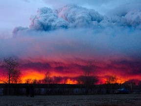 A wildfire moves towards the town of Anzac from Fort McMurray, Alberta., on Wednesday May 4, 2016. Alberta declared a state of emergency Wednesday as crews frantically held back wind-whipped wildfires.  (Jason Franson/The Canadian Press via AP) MANDATORY CREDIT