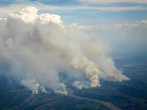 Wildfires burn in and around Fort McMurray, Alberta, on Wednesday, May 4, 2016. Jeff McIntosh/The Canadian Press via AP