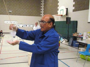 Richard Steevenzs, a retired research scientist, carries out a demonstration for students on Thursday May 5, 2016 in the gym at Errol Road Public School in Sarnia, Ont. The assembly was held to celebrate 20 years of the Adopt-a-Scientist program in local schools. (Paul Morden, The Observer)