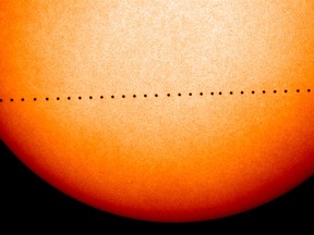This composite image of observations by NASA and the ESA's Solar and Heliospheric Observatory shows the path of Mercury during its November 2006 transit. On Monday, May 9, 2016, the solar system's smallest, innermost planet will resemble a black dot as it passes in front of the Sun. NASA says the event occurs only about 13 times a century. (Solar and Heliospheric Observatory/NASA/ESA via AP)