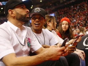 Toronto Blue Jays players Joey Bautista, left, and Marcus Stroman courtside as the Raptors faced the Pacers in Game 7 in Toronto Sunday, May 1, 2016. (Jack Boland/Toronto Sun)