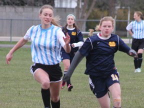 GDCI’s Jessica Millian (left), chases the ball down the field alongside a St. Michael’s player on April 28 for the junior girls soccer team. The Vikings lost 0-3. (Laura Broadley/Goderich Signal Star)