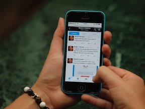 Twitter page of Canadian man, Robert Penner is seen on the screen of a mobile phone in Kathmandu, Nepal, Tuesday, May 3, 2016. Nepalese officials say they have ordered Penner to leave the country within two days for posting messages on social media that could disturb social harmony. (AP Photo/Niranjan Shrestha)