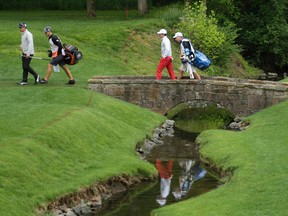 Rickie Fowler (left) and Rory McIlroy (second from right) walk to the 13th green during the first round of the Wells Fargo Championship in Charlotte, N.C., on Thursday, May 5, 2016. (Chuck Burton/AP Photo)