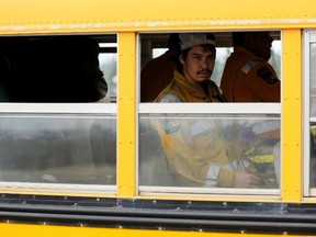 Firefighters arrive on a bus to help battle wildfires near Fort McMurray, Alberta, Canada, May 5, 2016. REUTERS/Chris Wattie