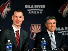 Newly appointed Arizona Coyotes general manager John Chayka speaks at a news conference announcing his promotion as head coach Dave Tippett listens, Thursday, May 5, 2016, in Glendale, Ariz. Chayka is the youngest GM in NHL history. (AP Photo/Matt York)