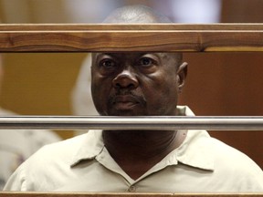 Lonnie David Franklin Jr. stands in court during his arraignment on 10 counts of murder and one count of attempted murder in Los Angeles Criminal Court, in Los Angeles, California, U.S. in this July 8, 2010 file photo. (REUTERS/Al Seib/Pool/File Photo)