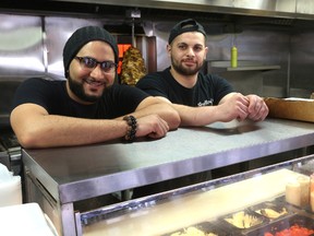 Yasser Ali and Yazan El-Shalabi, co-owners of Shelby?s Food Express on London?s Horton Street, are donating five per cent of their profits to the Red Cross to aid people displaced by the Fort McMurray, Alta., wildfire. (MIKE HENSEN, The London Free Press)