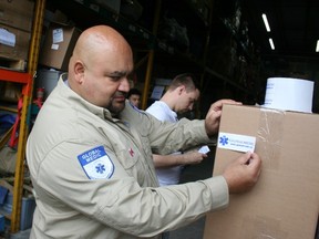 GlobalMedic executive director Rahul Singh prepares a box of hygiene kits to be sent to vulnerable evacuees displaced because of wildfires that are spreading through Alberta's Fort McMurray. (Terry Davidson/Toronto Sun)